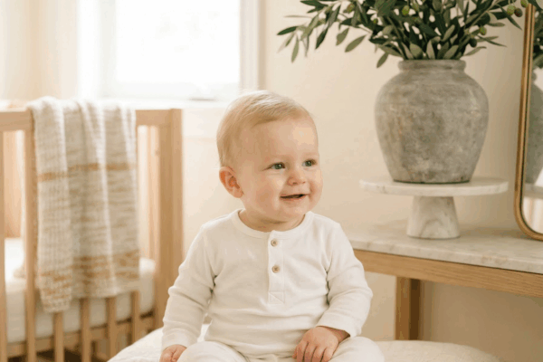 Adorable baby boy with marble and olive accents for Greek mythology baby names article