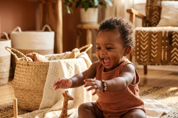 Baby Girl in a sunlit living room with warm wood and woven textiles — 200+ African Baby Girl Names With Deep Roots and Joyful Sounds