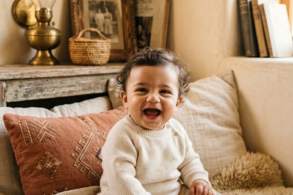 Baby Boy in a warmly lit corner with layered linens and brass accents — 200+ Arabic Baby Boy Names That Are Strong and Full of Meaning