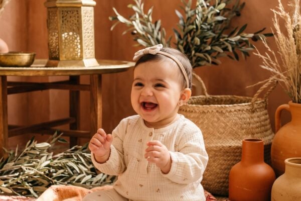 Baby Girl in A warm terracotta studio with brass lantern and geometric textiles — 200+ Arabic Baby Girl Names That Are Melodic and Meaningful