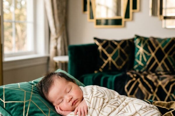 Baby Girl in an elegant room with art deco mirrors and geometric patterned fabrics — 200+ Art Deco Baby Names From the Glamorous 1920s and 1930s