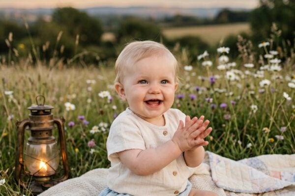 Baby Girl in a field at twilight with soft grass and emerging moonrise — 200+ Baby Names That Mean Moon — Dreamy, Luminous, and Deeply Rooted