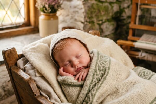 Baby Girl in a stone-walled cottage room with vintage Celtic pieces and afternoon light — 200+ Celtic Baby Girl Names That Feel Ancient and Enchanting
