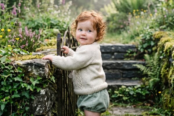 Baby Girl in a misty stone garden with wild ivy and moss — 200+ Celtic Mythology Baby Names — Wild, Poetic, and Wonderfully Untamed