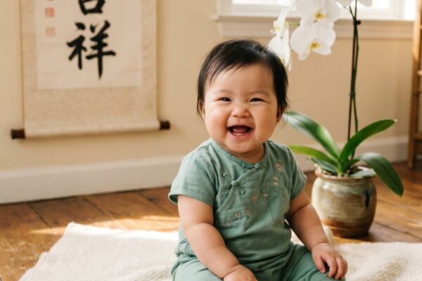 Baby in a studio with calligraphy art and warm natural window light — Chinese Baby Names With Beautiful Characters