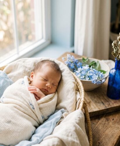 Baby Girl in a soft studio with pale blue backdrop near a window — 200+ Color-Inspired Baby Names From Azure to Indigo