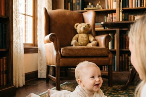Baby Boy in a sunlit vintage study with leather wingback chair and dark wooden bookshelves — Edwardian Baby Boy Names With Classic Gravitas
