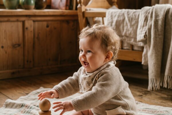 Baby Girl in a cozy Alpine cottage interior with natural wood and soft linens — 200+ German Baby Girl Names That Are Quietly Making a Comeback