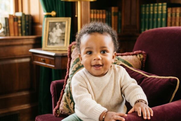 Baby Boy in an elegant study with dark wood furnishings and jewel-tone textiles — 200+ Gothic Boy Names for the Dark, Dramatic Soul