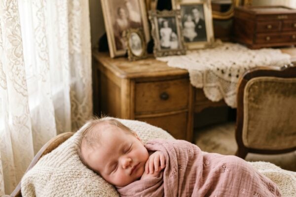 Baby Girl in a sunlit vintage sitting room with antique furnishings and heirlooms β 200+ Granny Chic Girl Names That Are Perfectly Vintage-Cool
