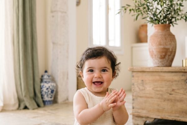 Baby Girl in a bright airy room with arched doorways and classical Mediterranean touches — Greek Baby Girl Names With Mythical Beauty
