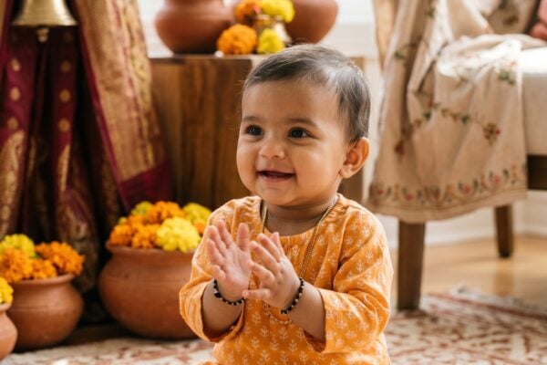 Baby Girl in an airy sun-lit room with fresh marigolds and Indian textiles — 250+ Hindu Baby Girl Names — Melodious, Sacred, and Full of Meaning
