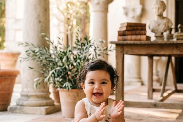 Baby Girl in a sunlit villa courtyard with classical stone columns and arches — 200+ Latin Baby Girl Names That Are Classic and Timeless