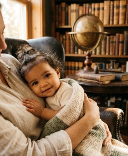 Baby Girl in a warm vintage study nook with leather chair and bookshelves — 200+ Light Academia Baby Names for the Cozy Scholar Aesthetic