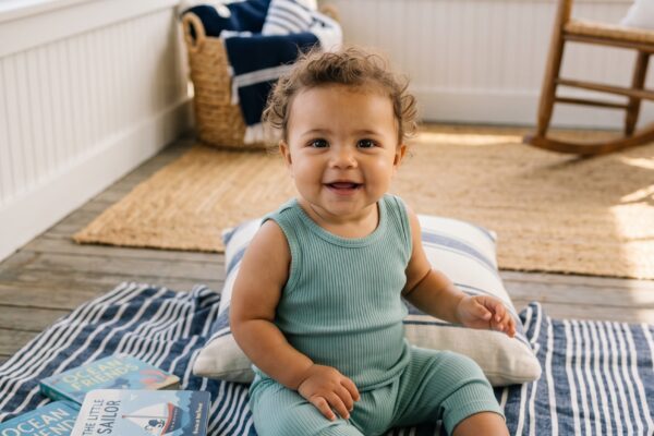 Baby Girl in a bright, airy sun room in a New England coastal cottage — 200+ New England Baby Names With Preppy Coastal Class