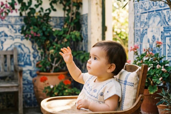 Baby Girl in a sun-drenched Mediterranean patio with Portuguese azulejo tiles — 200+ Portuguese Baby Girl Names With Romantic Lusophone Flair