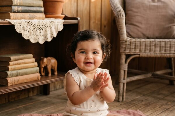 Baby Girl in a sun-warmed vintage porch with natural wood and wicker — 200+ Retro Baby Girl Names Making a Chic Comeback