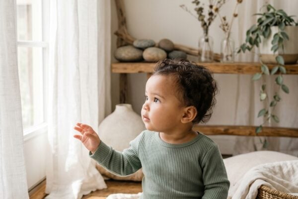 Baby Girl in a sunlit room with flowing sheer curtains near tall windows — 200+ River Baby Names That Flow Beautifully