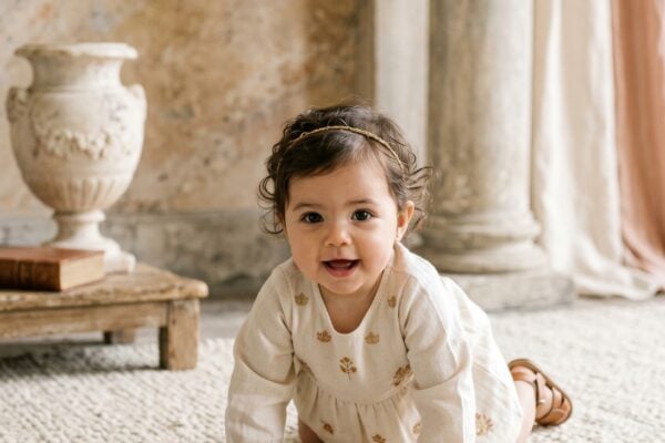 Baby Girl in a minimalist studio with soft marble backdrop and classical stone accents — 200+ Roman Mythology Baby Names — Ancient Power, Unmistakably Modern