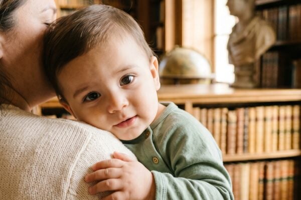 Baby Boy in a sunlit library with tall arched windows and wooden shelves — 200+ Saint Names for Boys — Faithful, Timeless, and Surprisingly Cool