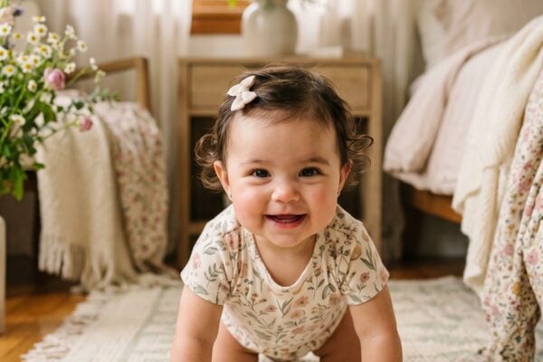 Baby Girl in a sunlit bedroom with sheer drapes and wildflowers — 200+ Soft Girl Names With Gentle, Dreamy Feminine Energy