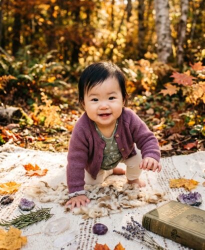 Baby in A sun-dappled forest clearing surrounded by golden autumn foliage — Spellbound Baby Names for Witchy Parents