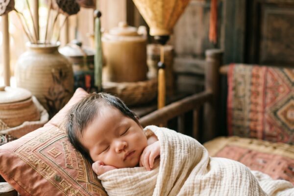 Baby Girl in a sun-lit corner with hanging Vietnamese silk lanterns and textiles — 200+ Vietnamese Baby Names That Are Musical and Meaningful