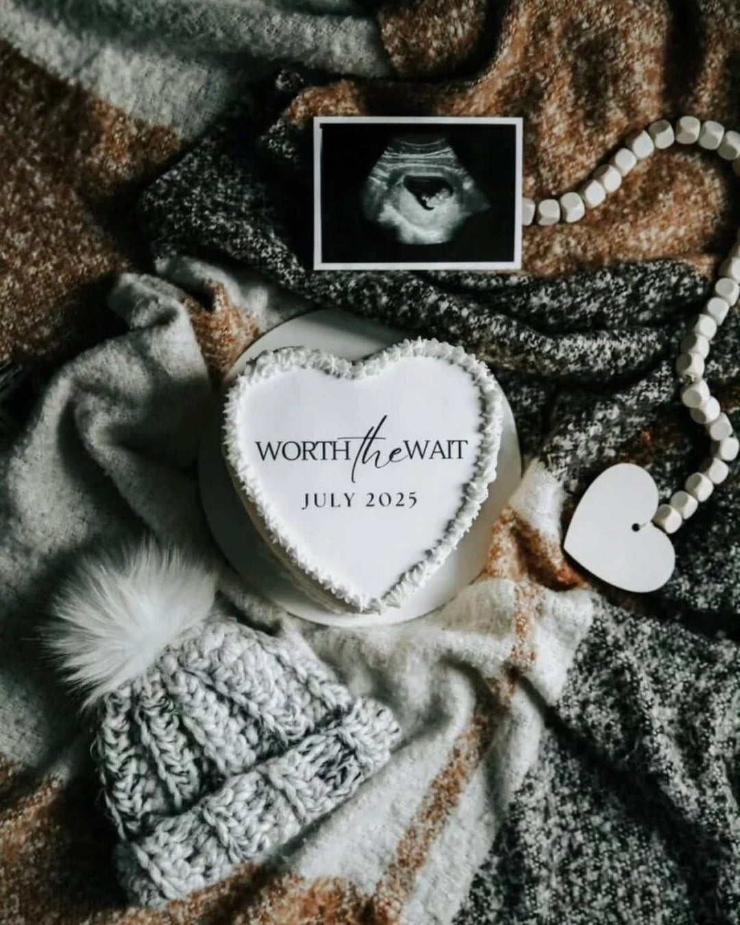 Christmas cake decorated with a worth the wait pregnancy announcement message