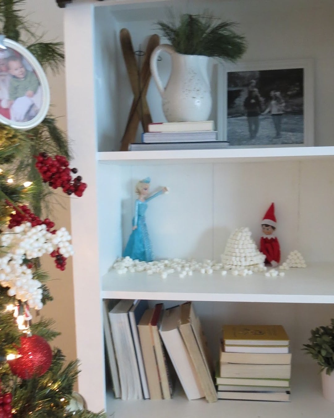 Elf on the Shelf tucked inside a small igloo made of hot-glued mini marshmallows