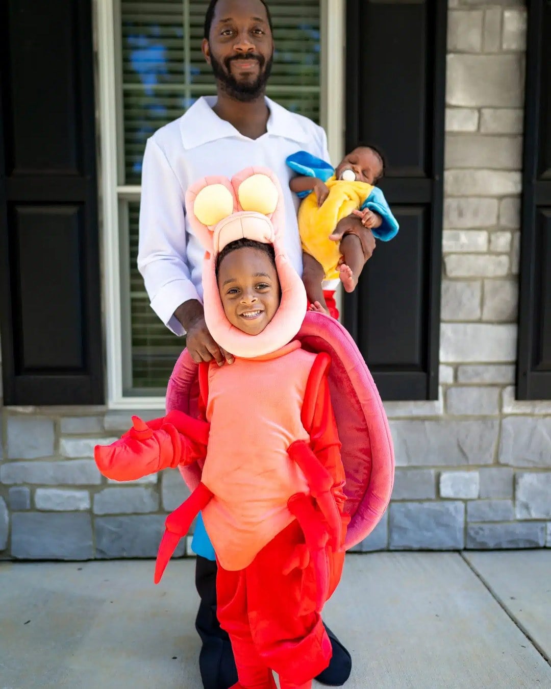 Family of four dressed as Ariel, Prince Eric, Sebastian, and Flounder from The Little Mermaid