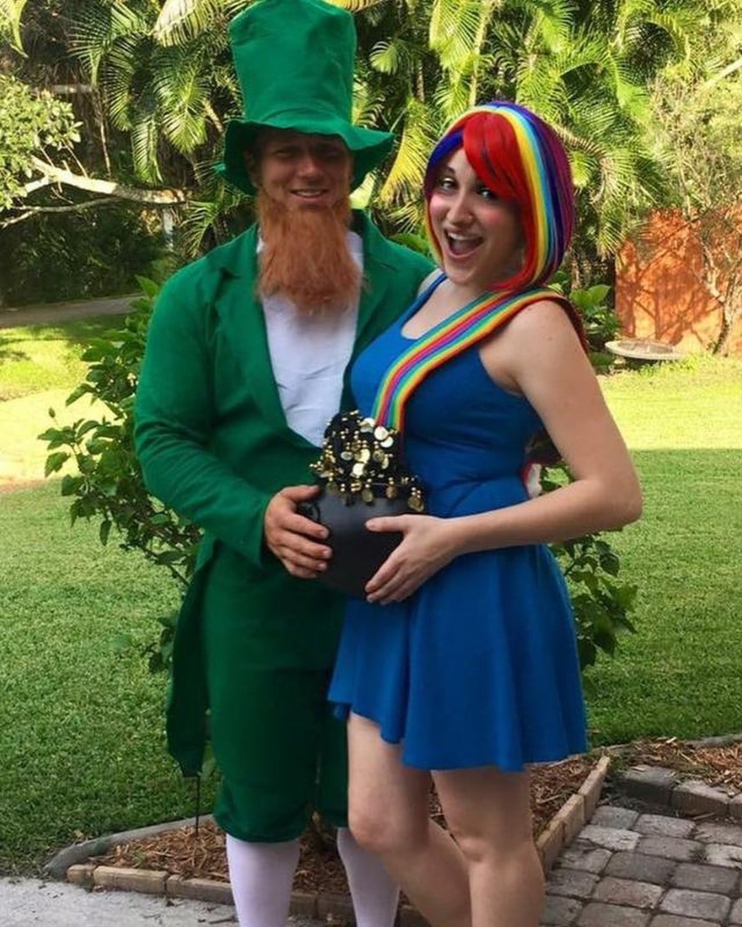 Pregnant woman wearing a rainbow top with belly painted as a pot of gold
