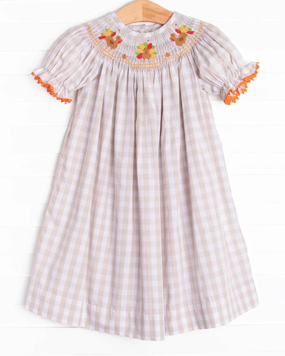 Tan and white gingham smocked bishop dress with smocked turkeys on the yoke and orange rick-rack on the sleeves