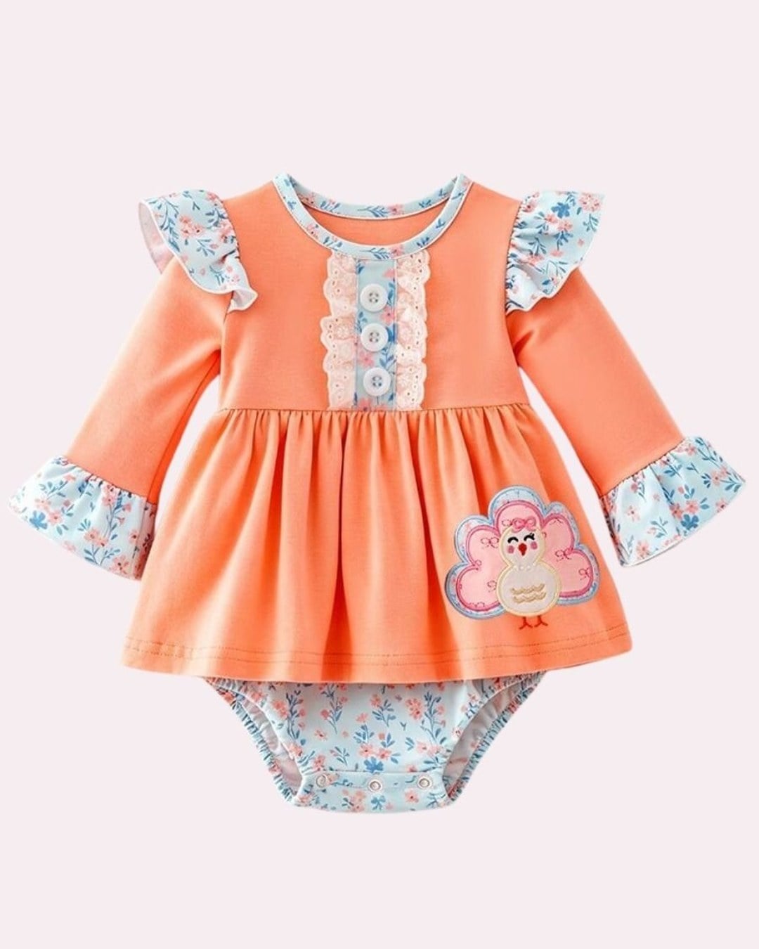 Peach long-sleeve baby romper with a skirt, floral ruffle sleeves, turkey appliqué and floral bloomers