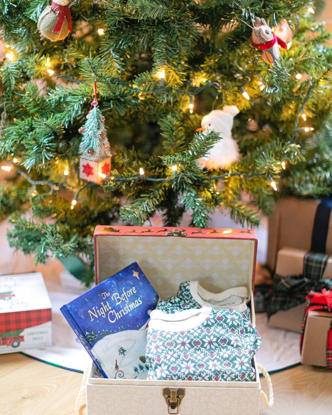 A Christmas Eve box holding pajamas, a holiday book and an ornament