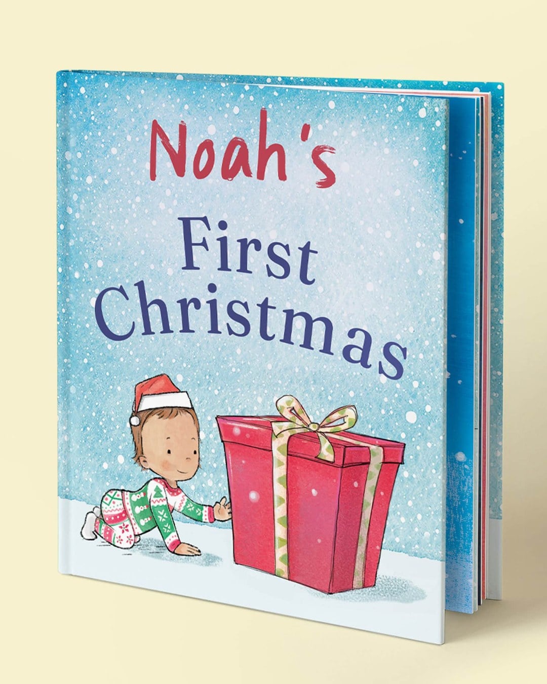 A hardcover children's book titled Noah's First Christmas with an illustrated baby in a Santa hat