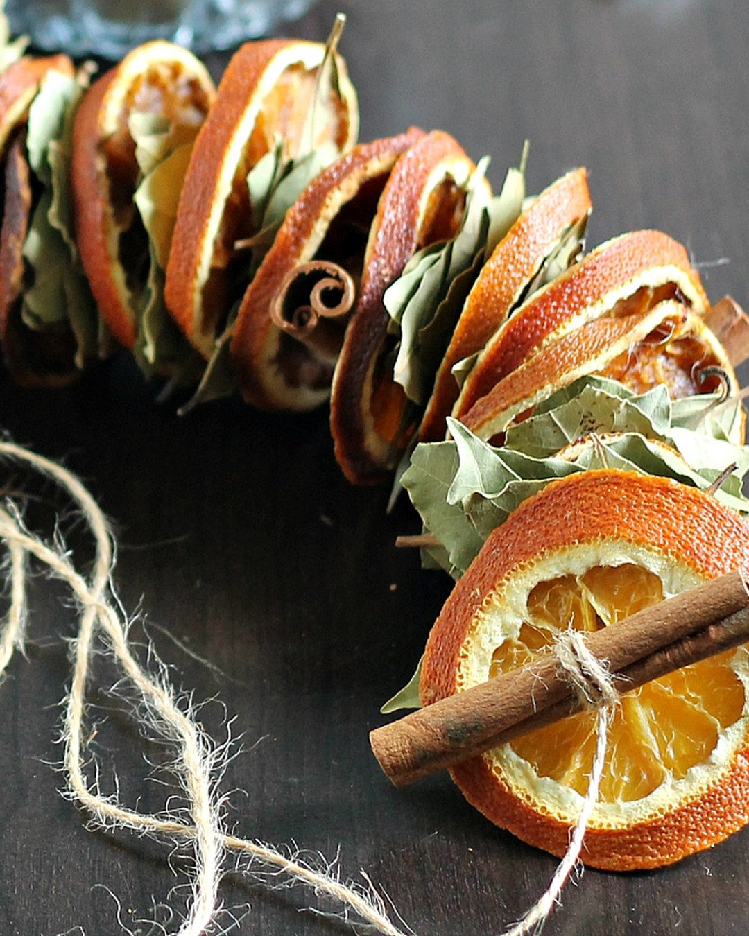 Garland of dried orange slices, bay leaves and cinnamon sticks strung on twine