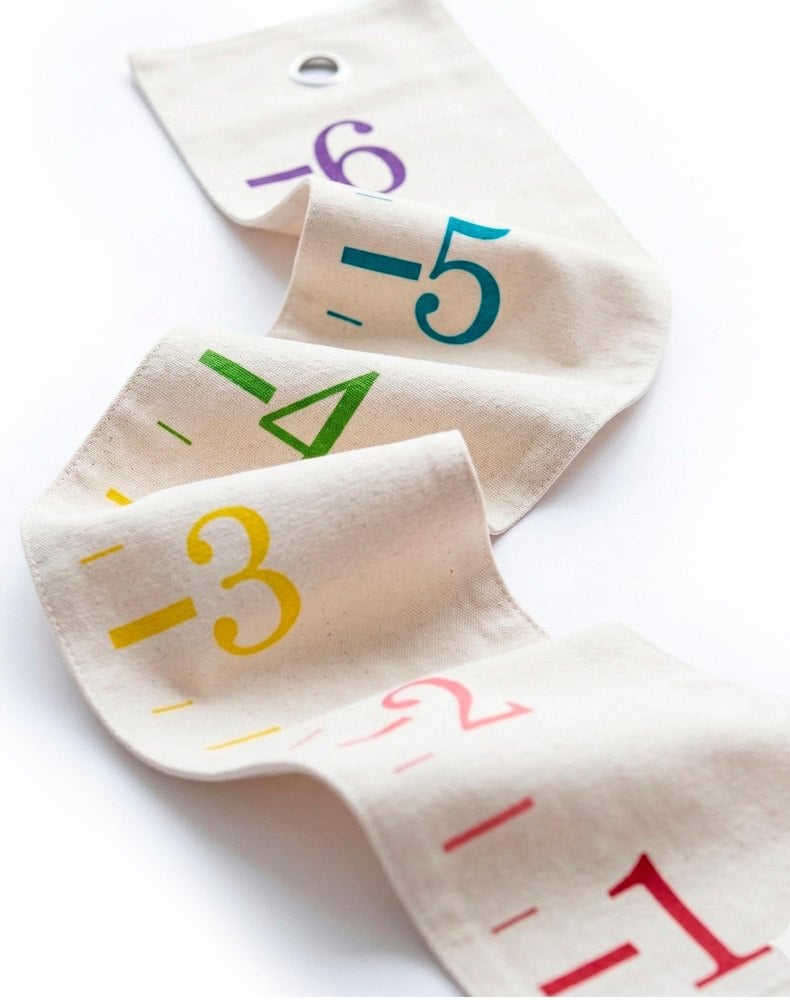 White Loft canvas growth chart with rainbow-colored ruler numbers